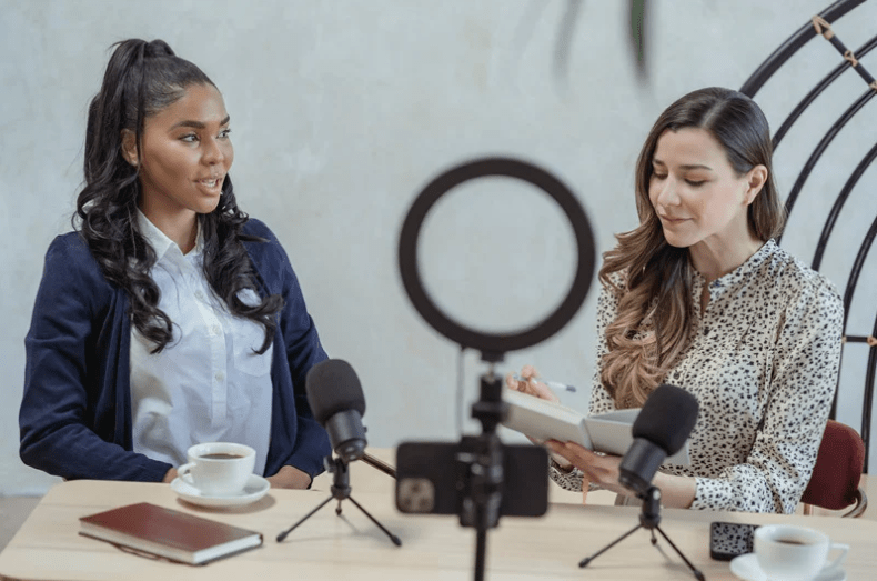 two women filming for social media