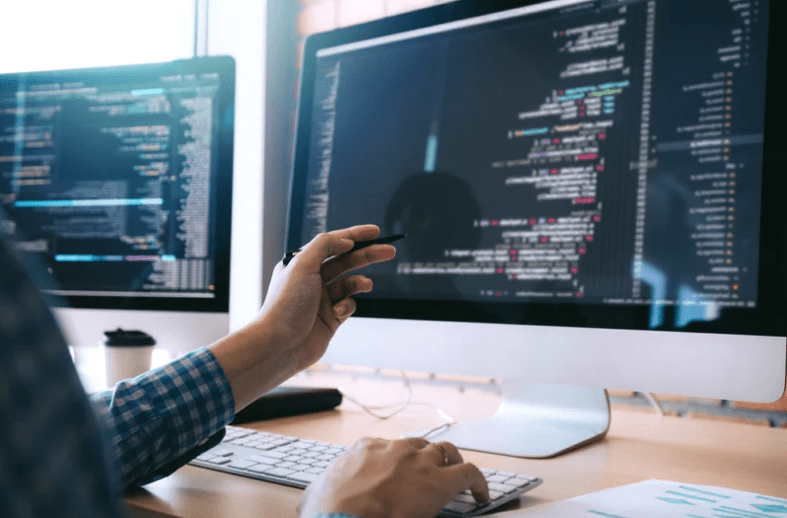 person at computer pointing