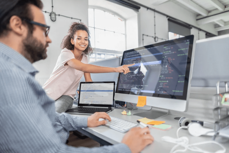 two coworkers on computer